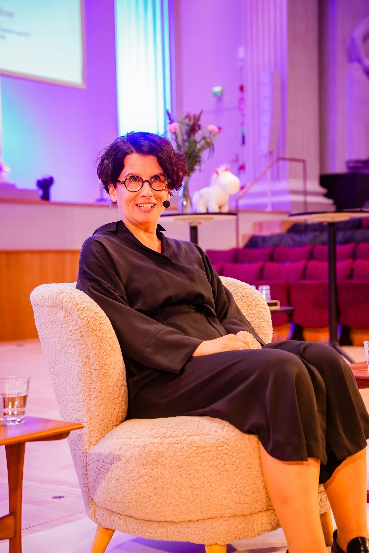 Hannele Korhonen seated in a warmly lit room in Helsinki